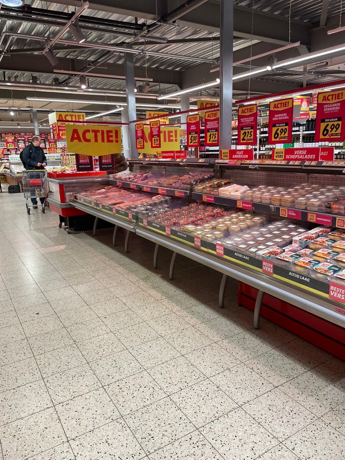 Koelmeubel met vlees en vega-producten met ACTIE-borden